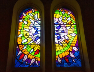 Decorative stained glass with motives from Christian religion used on windows in catholic church in...