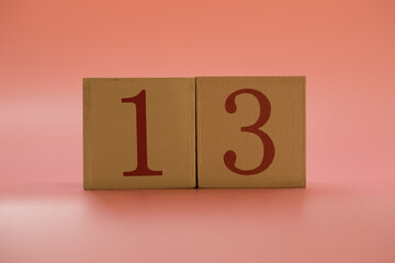 Numbers or dates on wooden cubes, thirteen