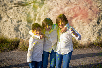 Children playing with colored powder, having fun.