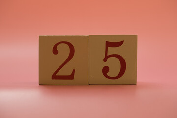 Numbers or dates on wooden cubes, twenty-five