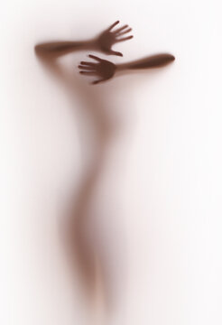 Diffuse silhouette of a pretty woman body with arms, hands and fingers, behind a textile surface. Cut out, separated, white background abstract image.