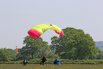 Skydiver landing in a field
