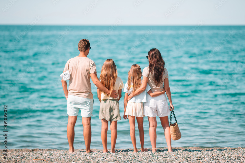 Poster happy family on the beach during summer vacation