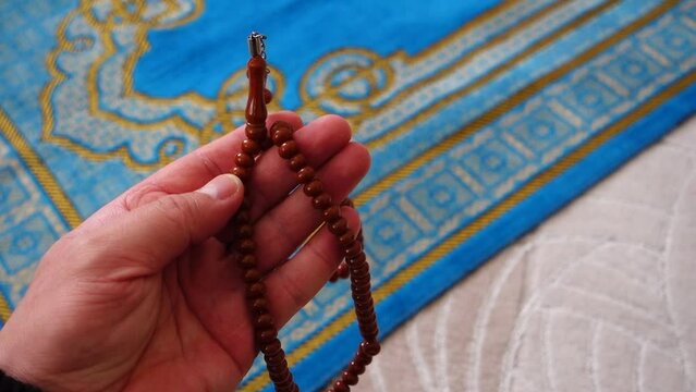 close-up prayer rug and rosary, Islam and prayer rug, on the prostration Muslims pray on,