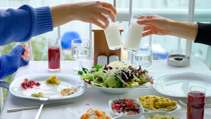 Women cheering Turkish raki in seafood restaurant 