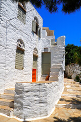 One of the charms of the Greek islands of the Cyclades (here, the island of Tinos), in the heart of the Aegean Sea, are the narrow streets: white houses, small flowered balconies and cobbled stairs