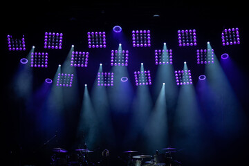 Dimmed stage overhead lights to illuminate musical concerts.