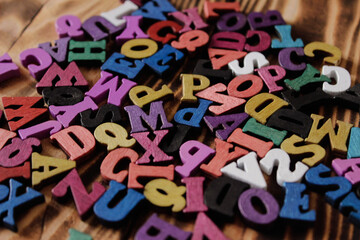 Multicolored letters of the alphabet. Volumetric multicolored letters. The alphabet is in a chaotic state. Letters as a symbol of reading. Reading English literature. Learning to read. 