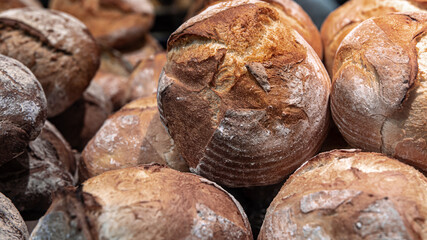 Large loaves of bread on the counter of a bakery.