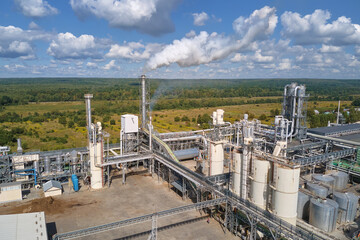 Obraz premium Aerial view of oil and gas refining petrochemical factory with high refinery plant manufacture structure. Global production and manufacturing concept