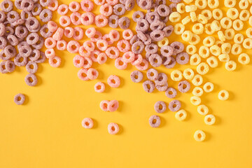 colorful breakfast cereals on yellow background top view