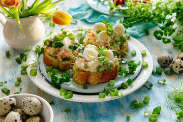 Sandwiches with the addition of traditional vegetable salad, quail eggs and fresh green onions. An idea for an Easter breakfast - 491102695