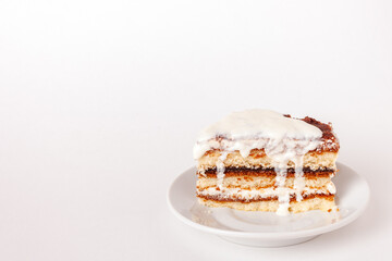 one piece of tiramisu with dripping cream on white background with copy space