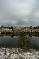 lake and tree  forest in the night . Night landscape. Nightsky and clouds . Stars in the sky . Lights of the city . 