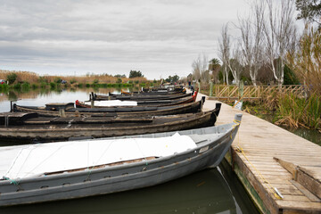 puerto de catarroja ,vista de barcos y barcas de madera típicos de pesca de la albufera de valencia amarrados a los muelles de madera .
