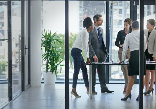 This Is Where Profits Are Born. Shot Of A Group Of Businesspeople Having A Serious Discussion In The Boardroom.