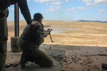 A soldier fires a machine gun israel . High quality photo