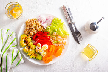 Fototapeta na wymiar Shrimp salad with avocado, tomatoes and quail eggs. diet food