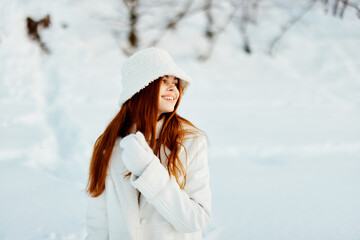 pretty woman in a white coat in a hat winter landscape walk Fresh air