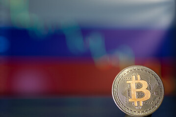 Bitcoin coin on the background of the Russian flag with a decline chart