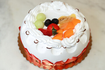 Fruit topping birthday cake on white background made at home