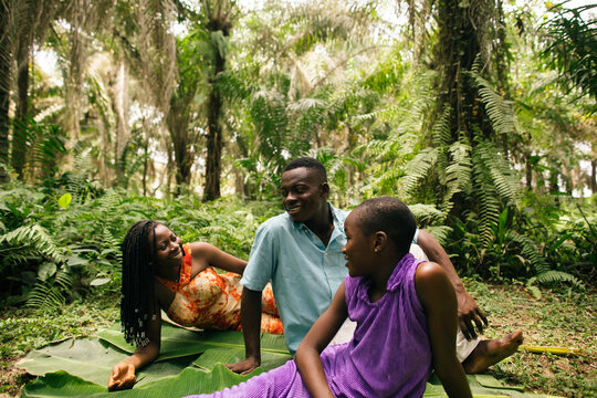 Portrait of a black african family of nature activists smiling together in the rainforest
