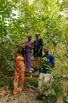 Portrait of black african farmers standing on a tree