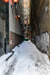Fototapeta premium Urban alleyway lights and fire escapes in winter