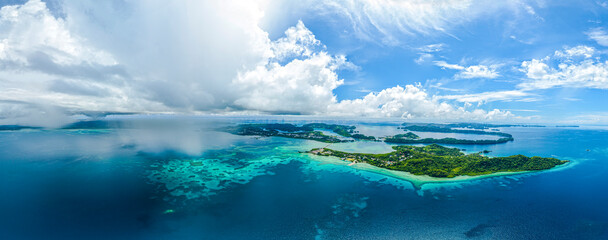 Aerial panorama of tropical islands clouds and rain showers