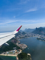 Aerial view through airplane window of Rio de Janeiro city, Brazil. Exuberant view of one of the...