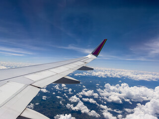 Obraz premium Aerial view through airplane window of Rio de Janeiro city, Brazil. Exuberant view of one of the most beautiful places in the world. Sunny day with some clouds