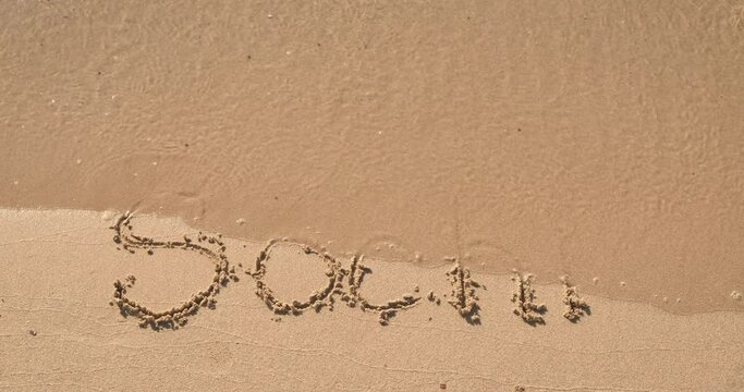 Sochi summer on shore. A view of a word sochi on the hot summer beach under the sun. A concept of summer holiday on Russian beaches.