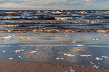 Baltic sea, waves and blue sky in sunny spring evening.