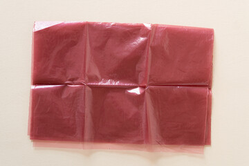 grungy plastic bag partly folded on a flat surface