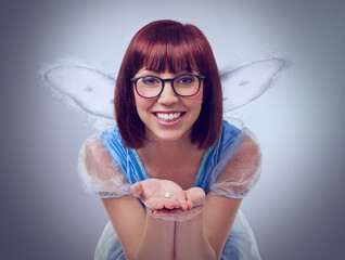 Look, its a first tooth. A cropped shot of a fairy godmother in a blue gown holding a tooth. - obrazy, fototapety, plakaty