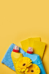 Cleaning service concept. Spring cleaning. Cleaning chemical bottles and supplies. House cleaning concept on colored background