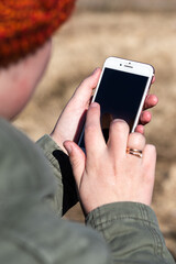 Woman using smartphone. Female touch black display smartphone outdoor.