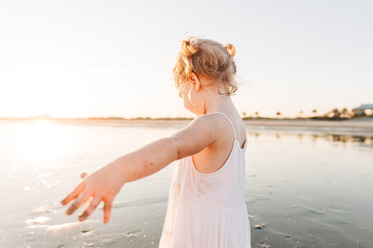 Young girl exploring at sunset in Charleston, South Carolina beach