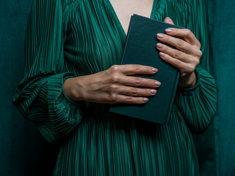 Girl in elegant dress holding a book