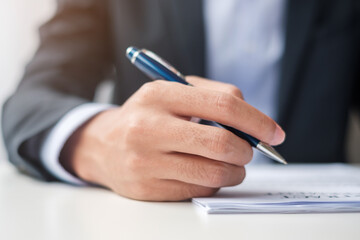 man signing on contract documents after reading, man holding pen and approve on business report. Contract agreement, law and deal concepts