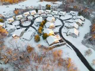 aerial view of residential community in winter after snow in dusk sunlight