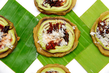 mexican sopes with grasshoppers and hot sauce on banana leaves, traditional mexican food