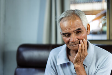 Asian senior man patients toothache while hands on cheek, Health problem retired asian old man hands touching on cheek while pain a toothache. health problem. Asian Older man suffering from toothache.