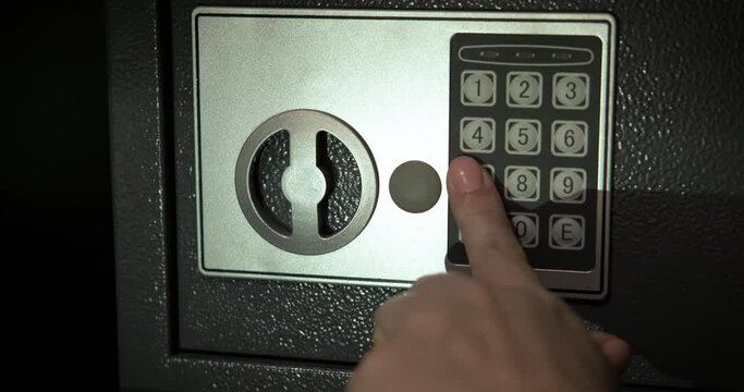 Combination lock with electronic key. A woman press a number combination on the locked electronic key.