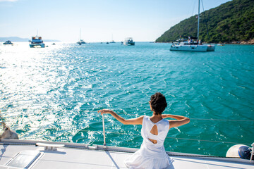 Portrait of Caucasian woman enjoy luxury lifestyle catamaran boat sailing and looking at beautiful...