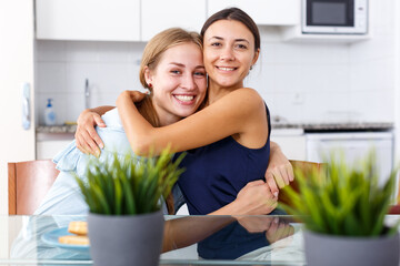 Obraz na płótnie Canvas Portrait of two happy female friends having good leisure at home