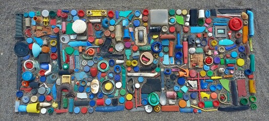 spilled plastic garbage on the beach, dirty sea sandy shore, environmental pollution, ecological problem, aerial view of plastic garbage on the beach, garbage on the beach, still lifes of plastics