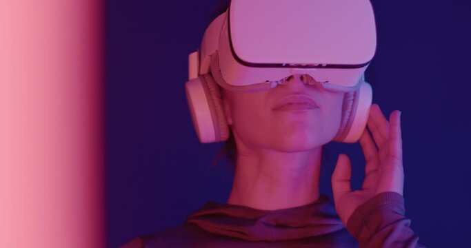 Young Adult Female Gamer Wearing Virtual Reality Headset Technology