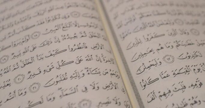 A shot of an opened Quran, the shot is slightly moving