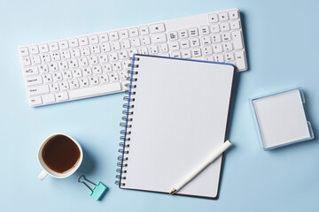 Bright office workspace. Work space with notepad, keyboard, coffee and glasses. Work space table desk. Flat lay, top view, copy space